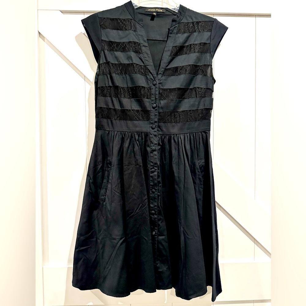 Cap sleeve black dress w/lace detail.